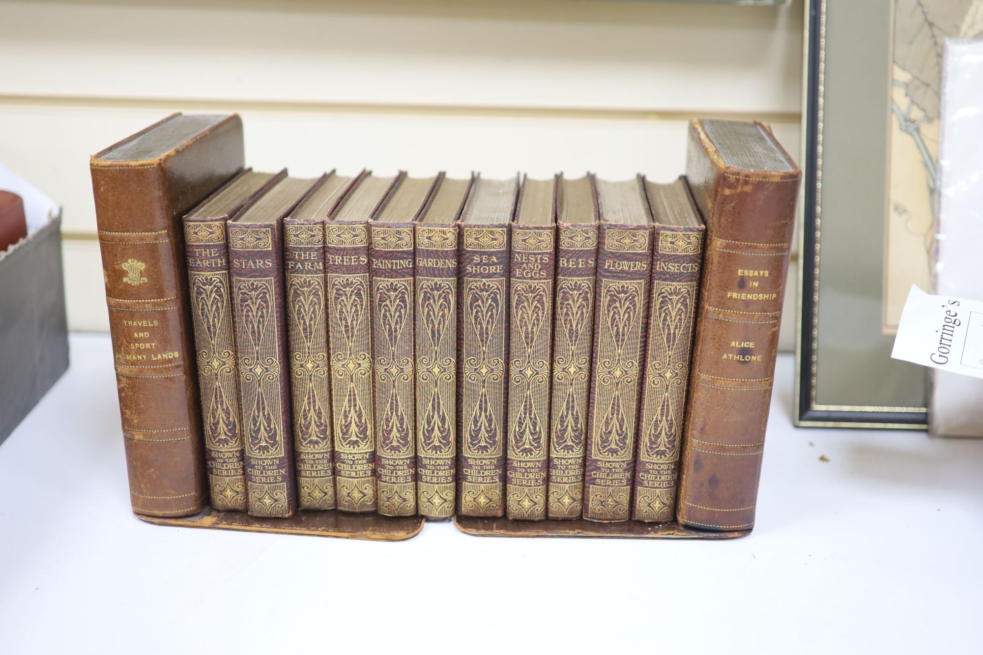 A pair of late 19th/early 20th century gilt tooled leather covered bookends, by Walter Jones of Sloane St. S.W, fashioned as books,